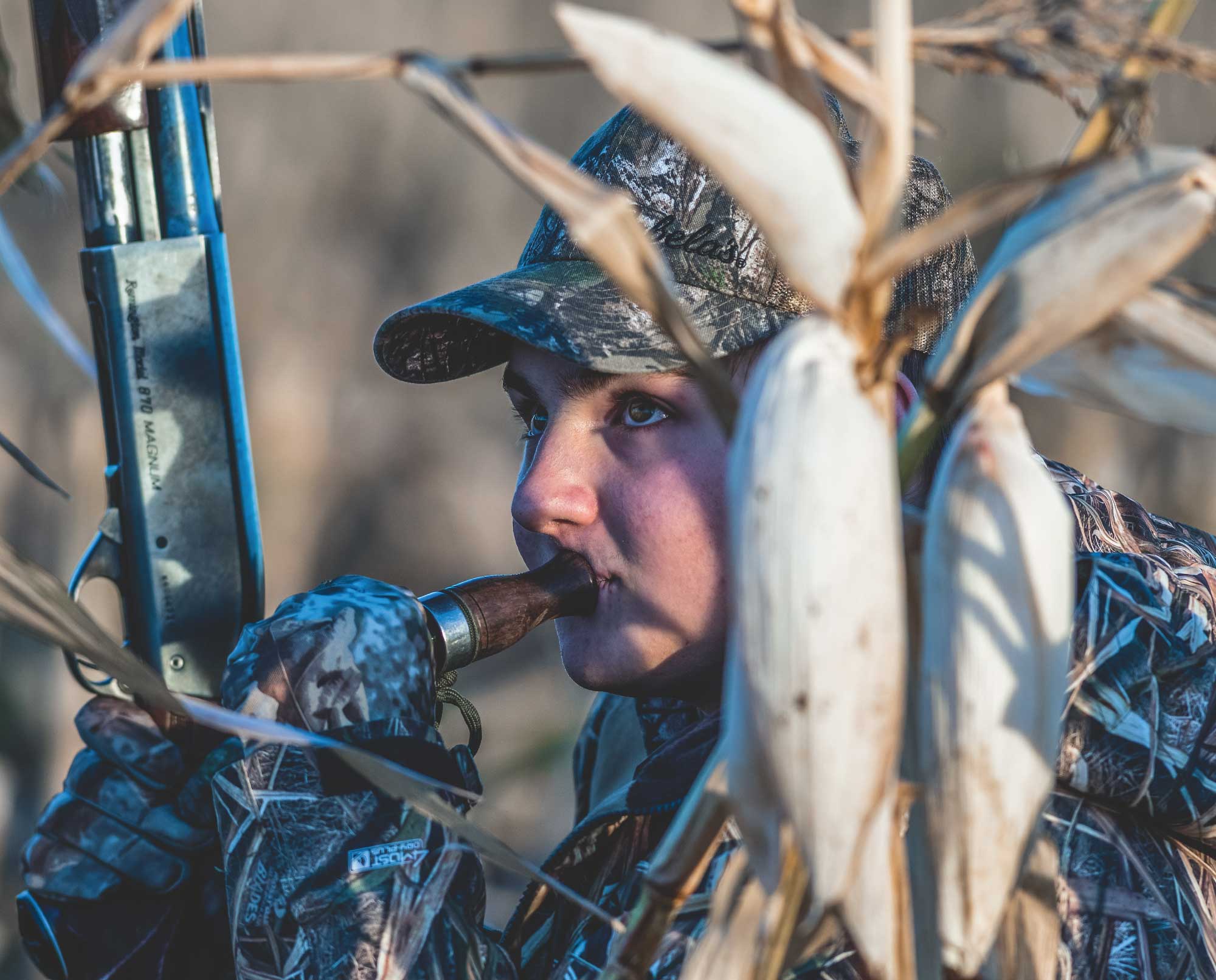 A goose hunter uses a call while hunting