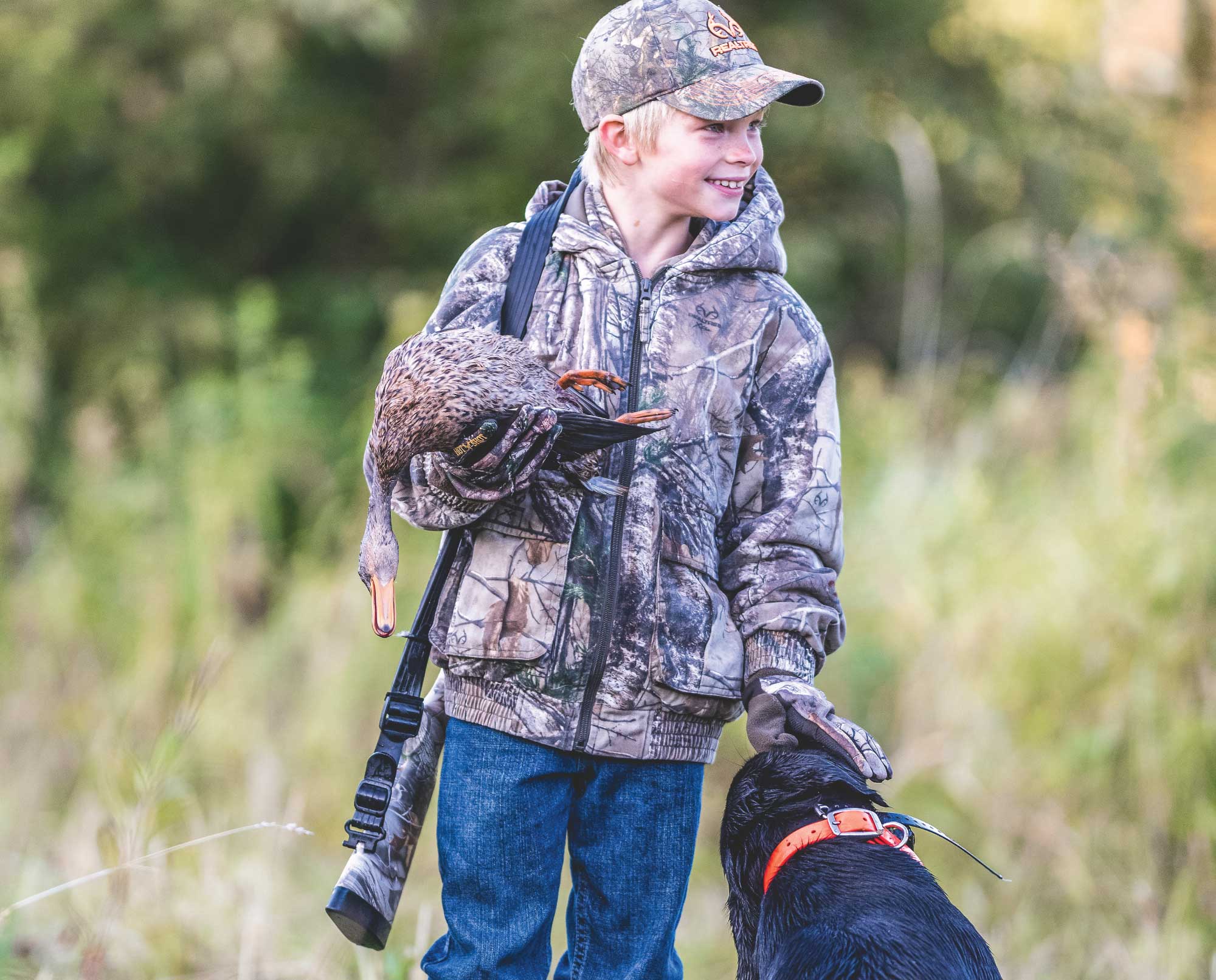 A young duck hunter with his first duck.