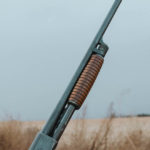 An Ithaca shotgun held by a bird hunter
